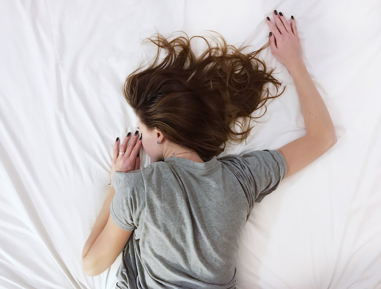 Woman Sleeping in a Bed