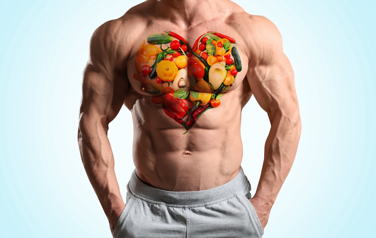A fit individual with a superimposed image of fruits and vegetables in the shape of a heart on their chest, symbolizing the importance of foods for muscle building.